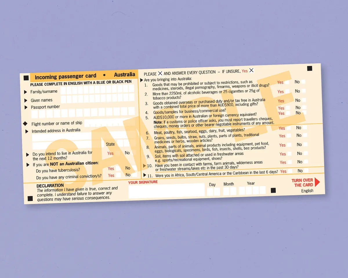 A hand filling out an Australian Incoming Passenger Card, specifically marking the declaration for vaping products.
