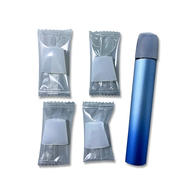 A close-up of a brand-new disposable vape showing a silicone plug in the mouthpiece and a clear plastic film sticker on the bottom airflow holes.