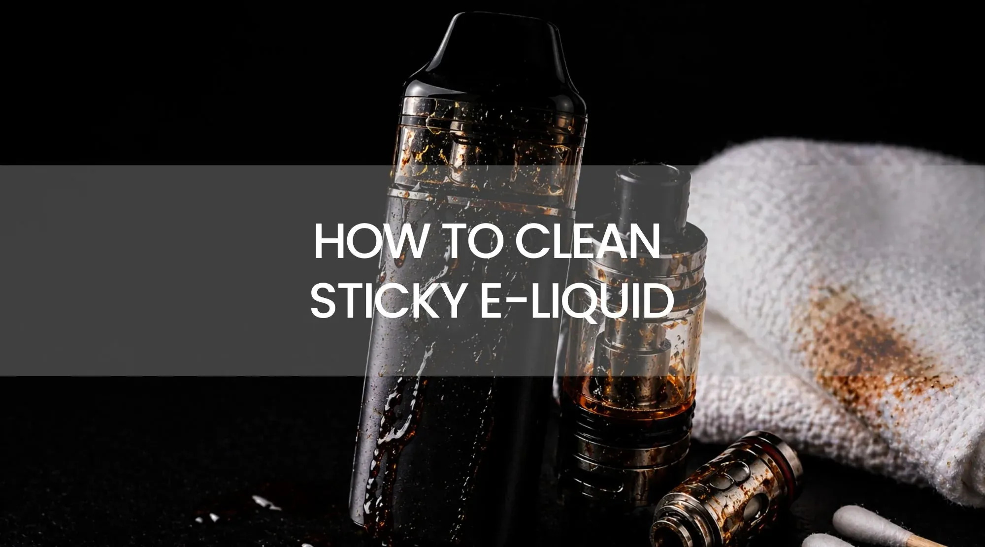 A hand using a cotton swab to clean condensation from the mouthpiece of a vape device.