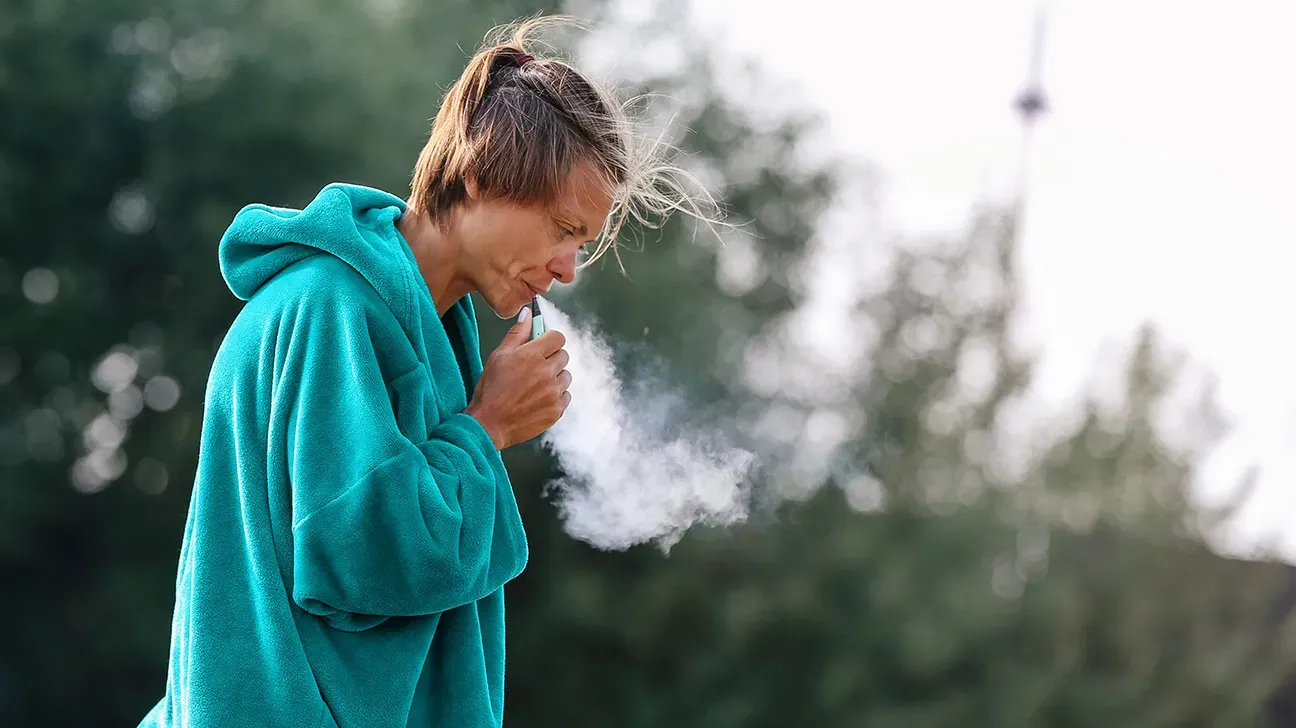 mid adult woman vaping smoking