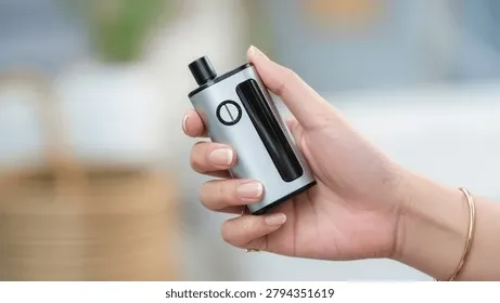 An image showing a person holding both a traditional cigarette and an e-cigarette, symbolizing dual use of smoking and vaping.