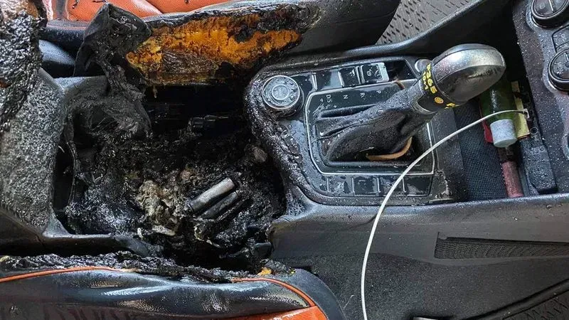A vape device emitting smoke or flames inside a car interior, illustrating a thermal runaway incident.