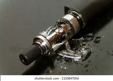 A close-up image of a disposable vape showing a visible crack or damage on its outer casing.
