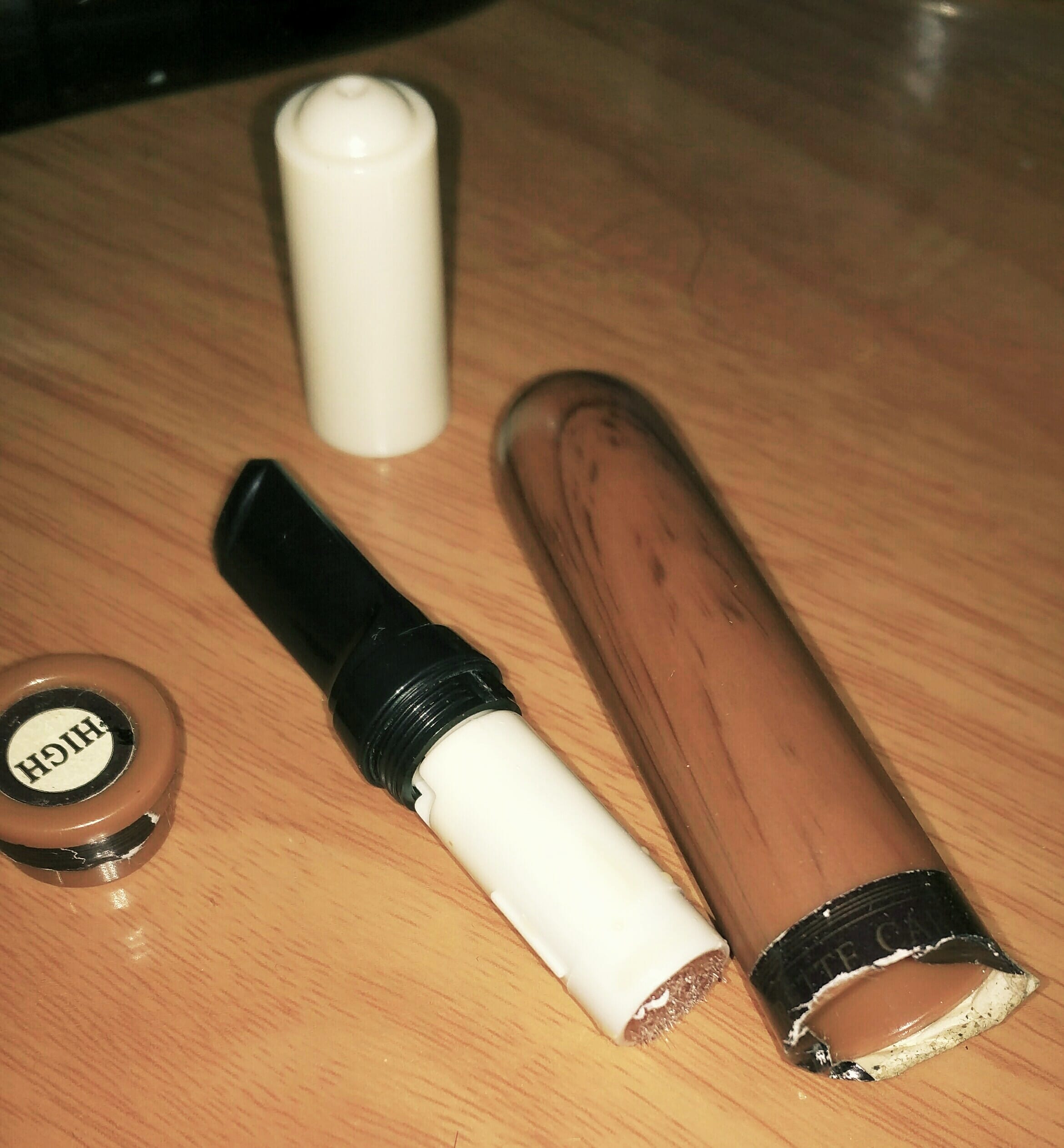 A dusty, forgotten disposable vape discovered under a sofa cushion, indicating it has been unused for weeks.