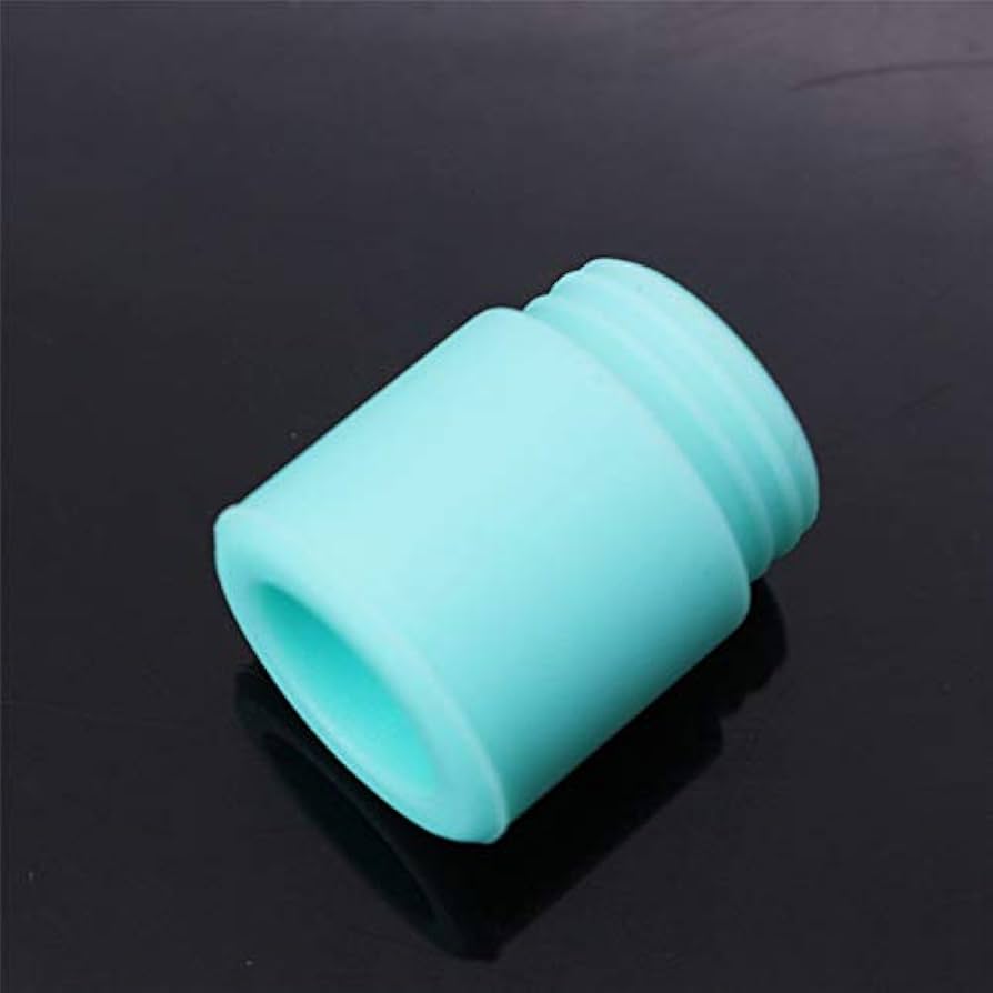 A close-up of a persons fingertip partially covering one of the airflow intake holes at the bottom of a disposable vape device.